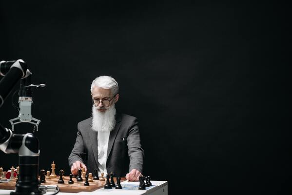 Man playing chess with machine